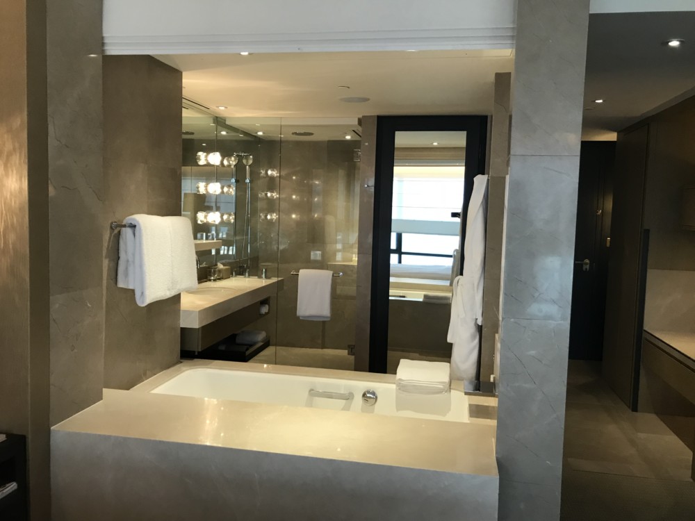 a bathroom with a tub and a mirror