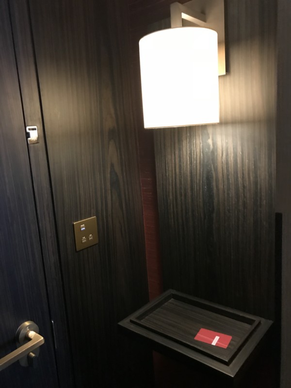 a door with a light on the wall