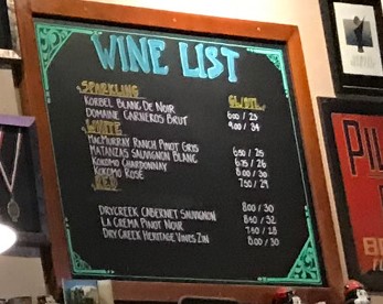 a menu board with a list of wine