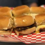 a plate of burgers on a red and white checkered paper