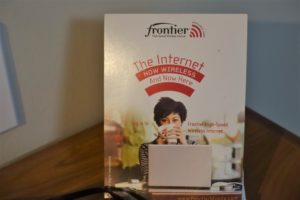a white box with a woman holding a cup with a laptop on it