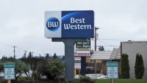 a sign board with a blue and white logo