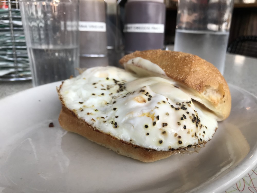 a plate with a sandwich and a egg on it