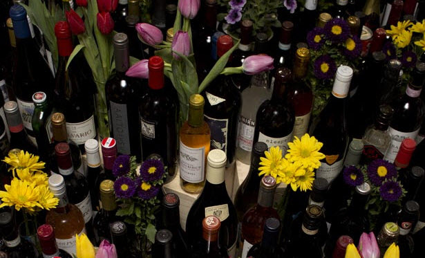 a bunch of wine bottles and flowers
