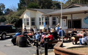 a group of people sitting at tables outside a building